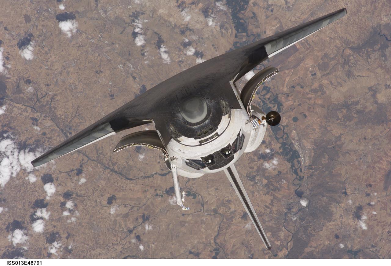 ISS013-E-48791 (6 July 2006)  --- The Space Shuttle Discovery approaches the International Space Station for docking but before the link-up occurred, the orbiter "posed" for a thorough series of inspection photos. Discovery docked at the station's Pressurized Mating Adapter 2 at 9:52 a.m. CDT, July 6, 2006.