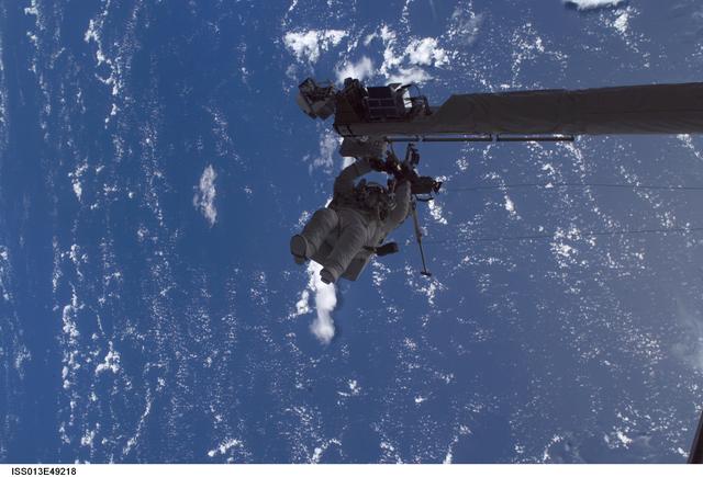 NASA image: Sellers anchored to the Space Shuttle Discoverys RMS OBSS foot restraint during STS-121 EVA