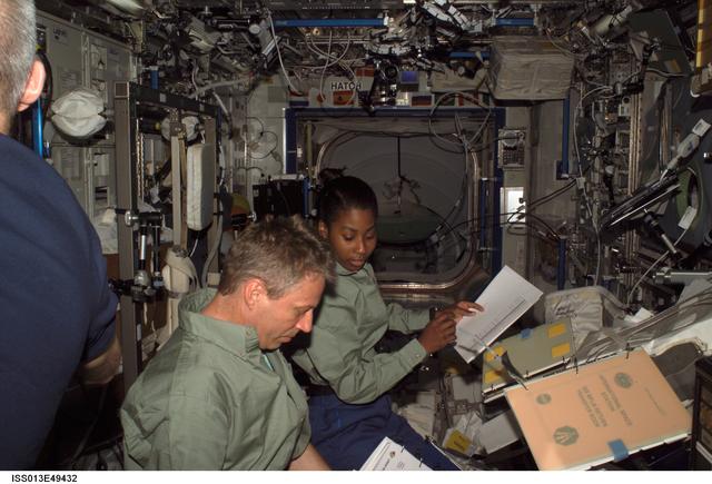 NASA image: Reiter and Wilson look over procedures in the U.S. Laboratory during Expedition 13