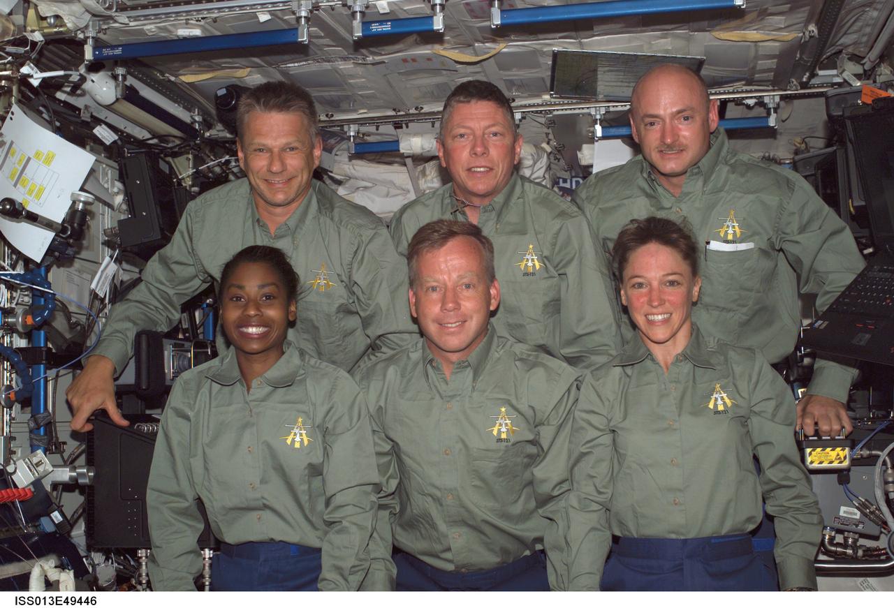 ISS013-E-49446 (9 July 2006) --- The STS-121 crewmembers gather for an in-flight crew photo in the Destiny laboratory of the International Space Station. From the left (bottom) are astronauts Stephanie D. Wilson, mission specialist; Steven W. Lindsey, commander; and Lisa M. Nowak, mission specialist. From the left (top) are astronauts Piers J. Sellers, Michael E. Fossum, both mission specialists; and Mark E. Kelly, pilot.