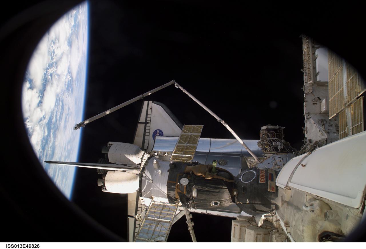 ISS013-E-49826 (11 July 2006) --- This scene, photographed from the International Space Station while docked with Space Shuttle Discovery, shows the orbiter, the orbiter's Remote Manipulator System (RMS) arm, the Space Station RMS (Canadarm2), the Orbiter Boom and Sensor System (OBSS) and a Soyuz vehicle docked with the orbital outpost.