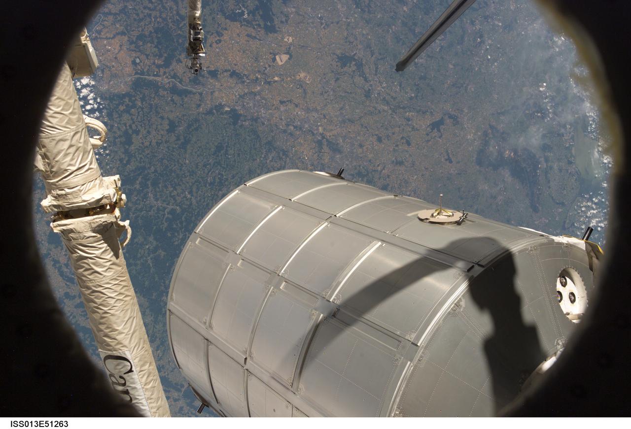 ISS013-E-51263 (14 July 2006) --- Canadarm2 or the Space Station Remote Manipulator System (SSRMS) arm grasps the Italian-built Multi-Purpose Logistics Module Leonardo to place it back in Discovery's cargo bay. On the other end of the arm, inside the shirt sleeve environment of the Destiny laboratory on the International Space Station, astronauts Stephanie D. Wilson and Lisa M. Nowak, STS-121 mission specialists, were in control of the transfer. The MPLM was being moved from its temporary parking place on the station's Unity node to the payload bay of Discovery for the return trip to Earth.