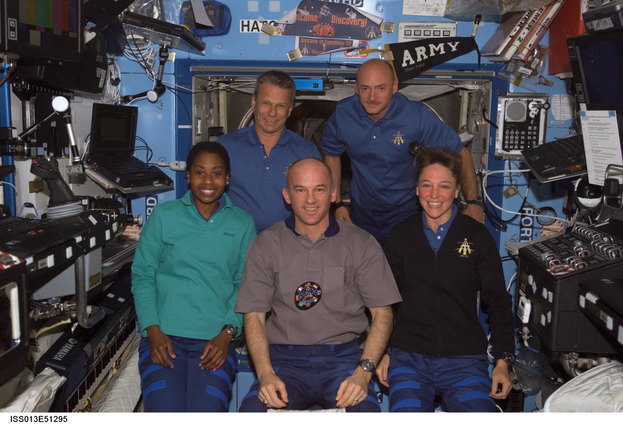 ISS013-E-51295 (14 July 2006) --- Crewmembers onboard the International Space Station gather for a photo in the Destiny laboratory while Space Shuttle Discovery was docked with the station. From the left (front) are astronauts Stephanie D. Wilson, STS-121 mission specialist; Jeffrey N. Williams, Expedition 13 NASA space station science officer and flight engineer; and Lisa M. Nowak, STS-121 mission specialist. From the left (back) are astronauts Piers J. Sellers and Mark E. Kelly, STS-121 mission specialist and pilot, respectively.