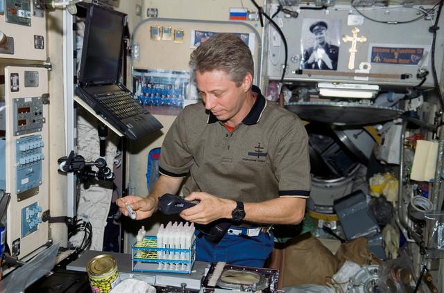 NASA image: Reiter working in the Service Module (SM)/Zvezda during Expedition 13