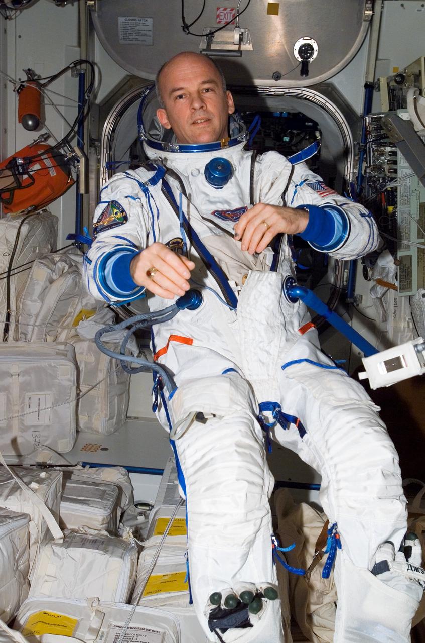 ISS013-E-60760 (26 July 2006) --- Attired in a Russian Sokol launch and entry suit, astronaut Jeffrey N. Williams, Expedition 13 NASA space station science officer and flight engineer, floats in the Unity node of the International Space Station.