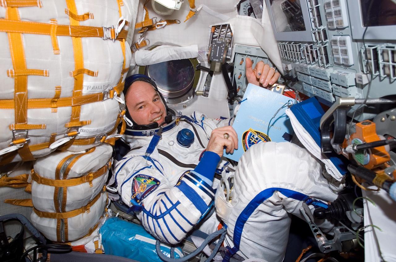 ISS013-E-60772 (26 July 2006) --- Attired in a Russian Sokol launch and entry suit, astronaut Jeffrey N. Williams, Expedition 13 NASA space station science officer and flight engineer, is photographed in the TMA-8 Soyuz spacecraft docked to the International Space Station.