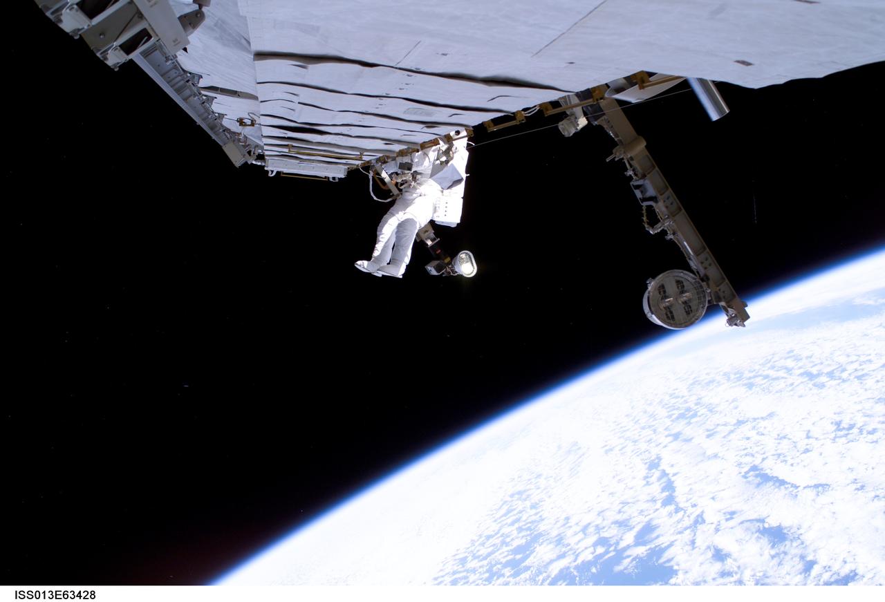 ISS013-E-63428 (3 August 2006) --- Astronaut Thomas Reiter, who represents the European Space Agency on the Expedition 13 crew, works on a cooling line in the S1 truss of the International Space Station during a 5-hour, 54-minute spacewalk on August 3.