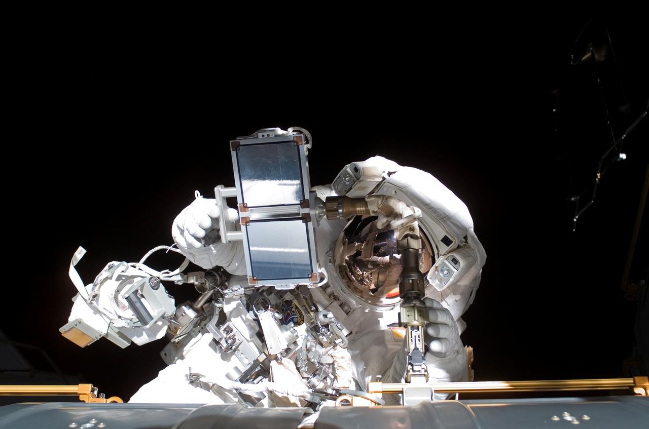 ISS013-E-63434 (3 Aug. 2006) --- Astronaut Thomas Reiter, who represents the European Space Agency on the Expedition 13 crew, is seen with the reinforced carbon carbon (RCC) sample case which was one of the final major planned tasks for a 5-hour, 54-minute spacewalk that he shared with astronaut Jeffrey N. Williams (out of frame), flight engineer and NASA ISS science officer.