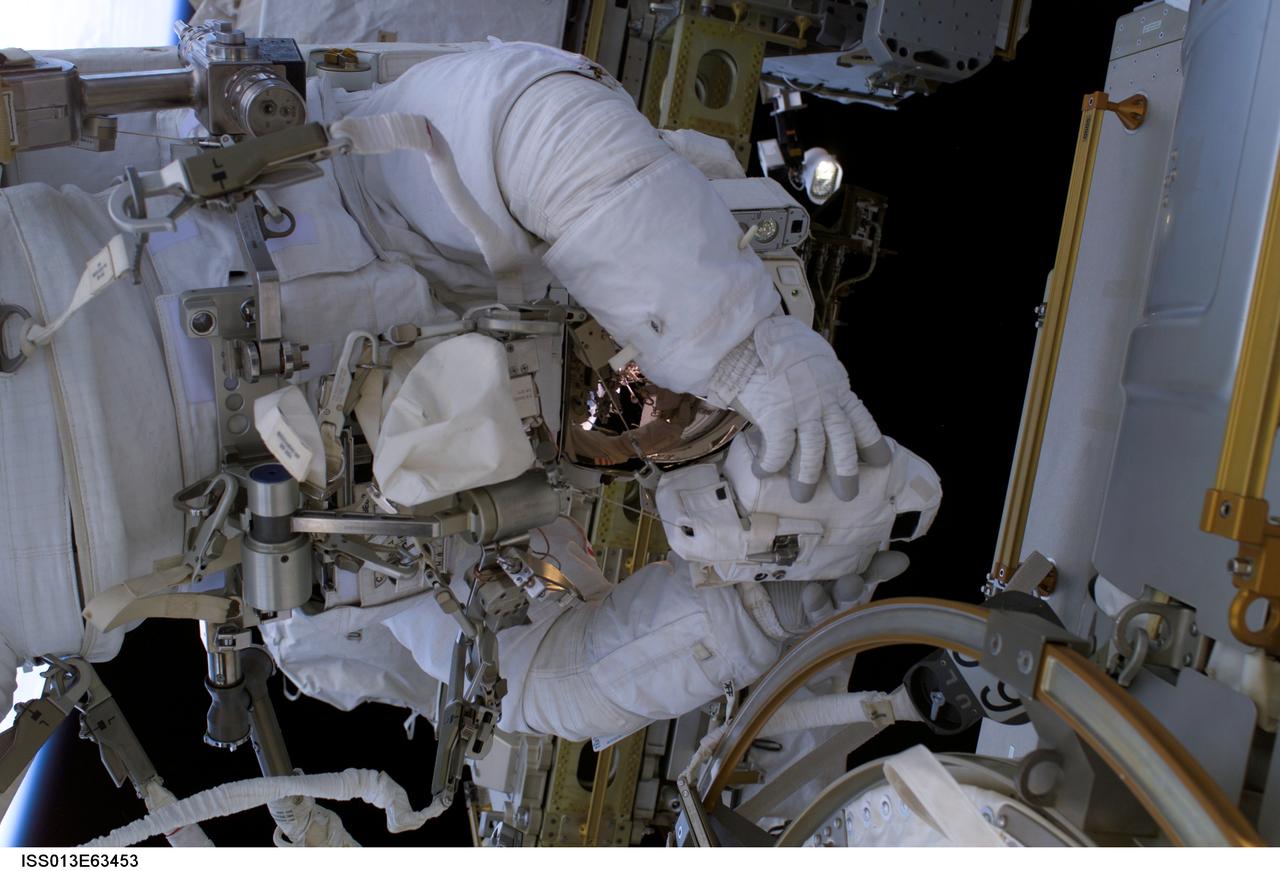 ISS013-E-63453 (3 August 2006) --- Astronaut Thomas Reiter, who represents the European Space Agency on the Expedition 13 crew, handles the infrared camera used to photograph a set of reinforced carbon carbon (RCC) samples for possible detection of damage caused by variations in temperature between sound and damaged RCC test sections.