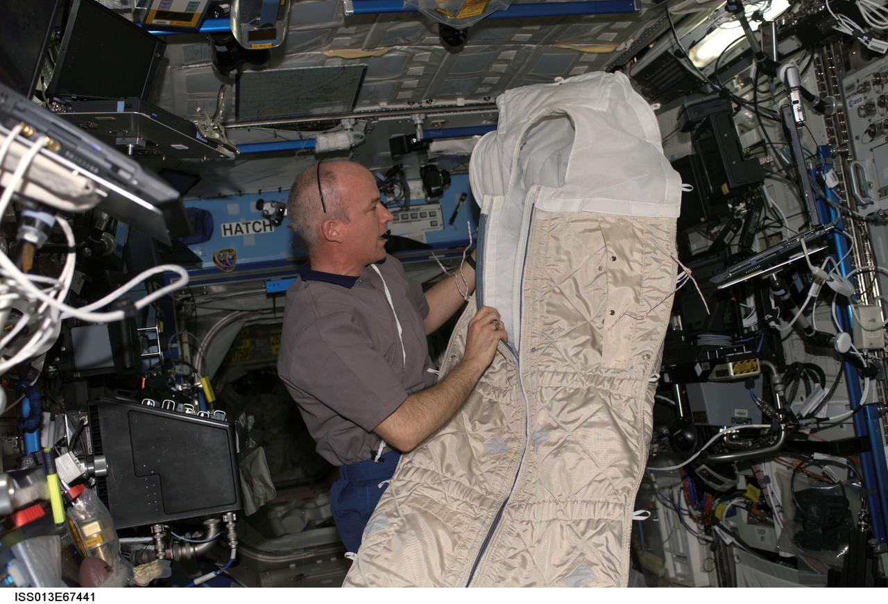ISS013-E-67441 (17 Aug. 2006) --- Astronaut Jeffrey N. Williams, Expedition 13 NASA space station science officer and flight engineer, holds a sleeping bag while conducting an educational teleconference with the Boys and Girls Clubs of Middle Tennessee in Nashville, via Ku- and S-band in the Destiny laboratory of the International Space Station, with audio and video relayed to the Mission Control Center at Johnson Space Center.