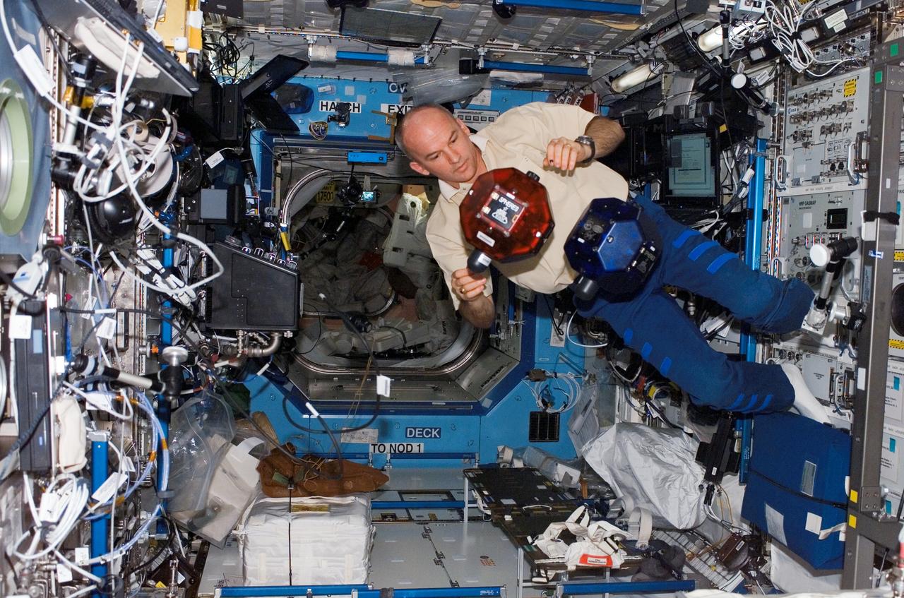 ISS013-E-68303 (19 Aug. 2006) --- Astronaut Jeffrey N. Williams, Expedition 13 NASA space station science officer and flight engineer, does a check of the Synchronized Position Hold, Engage, Reorient, Experimental Satellites (SPHERES) Beacon / Beacon Tester in the Destiny laboratory of the International Space Station.