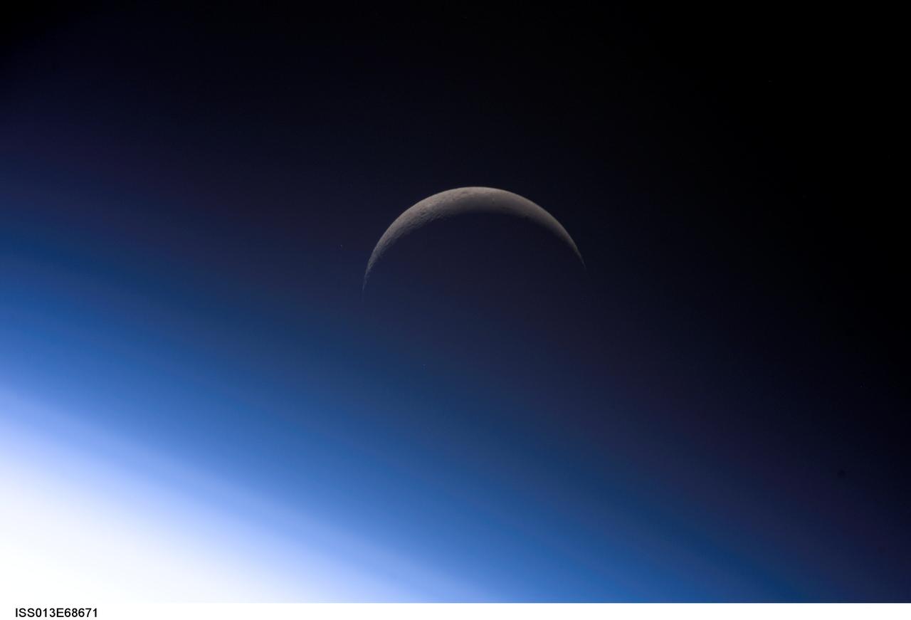 ISS013-E-68671 (18 Aug. 2006) --- A crescent moon is visible in this view of Earth's horizon and airglow, photographed by an Expedition 13 crewmember on the International Space Station.