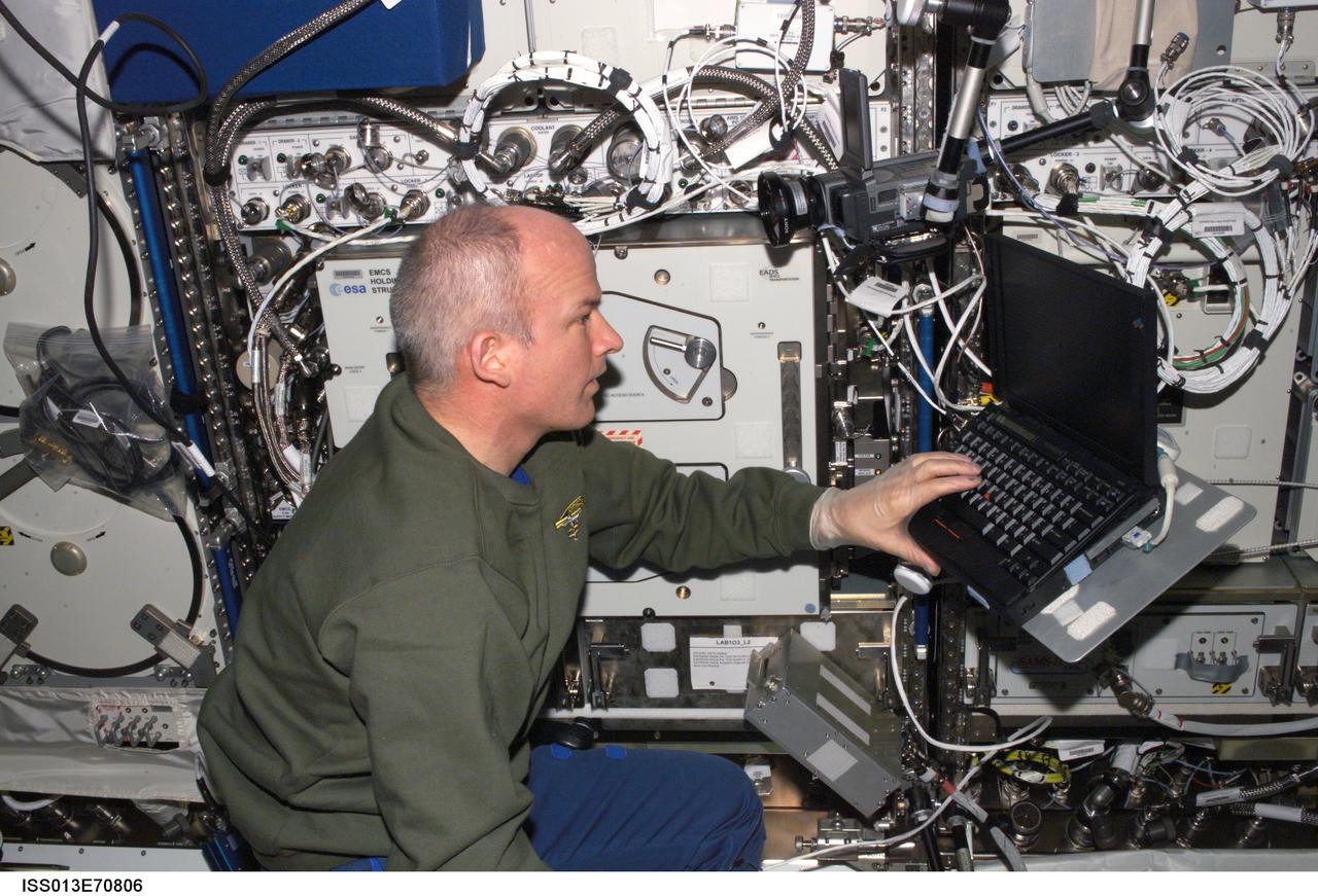 ISS013-E-70806 (22 Aug. 2006) --- Astronaut Jeffrey N. Williams, Expedition 13 NASA space station science officer and flight engineer, uses a computer in the Destiny laboratory of the International Space Station.