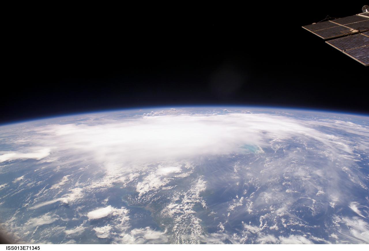 ISS013-E-71345 (28 August 2006) --- The crewmembers aboard the International Space Station took this oblique picture of Ernesto on Earth's horizon early afternoon on August 28, 2006. The tropical storm's center was located near 20.3 degrees north latitude and 75.7 degrees west longitude when the photo was taken. Movement was toward the northwest at 9 nautical miles per hour. Maximum sustained winds were at 35 nautical miles with gusts to 45 nautical miles. Ernesto had earlier passed between the east side of the Dominican Republic and Grand Turk Island (the light blue area to the right of center frame).