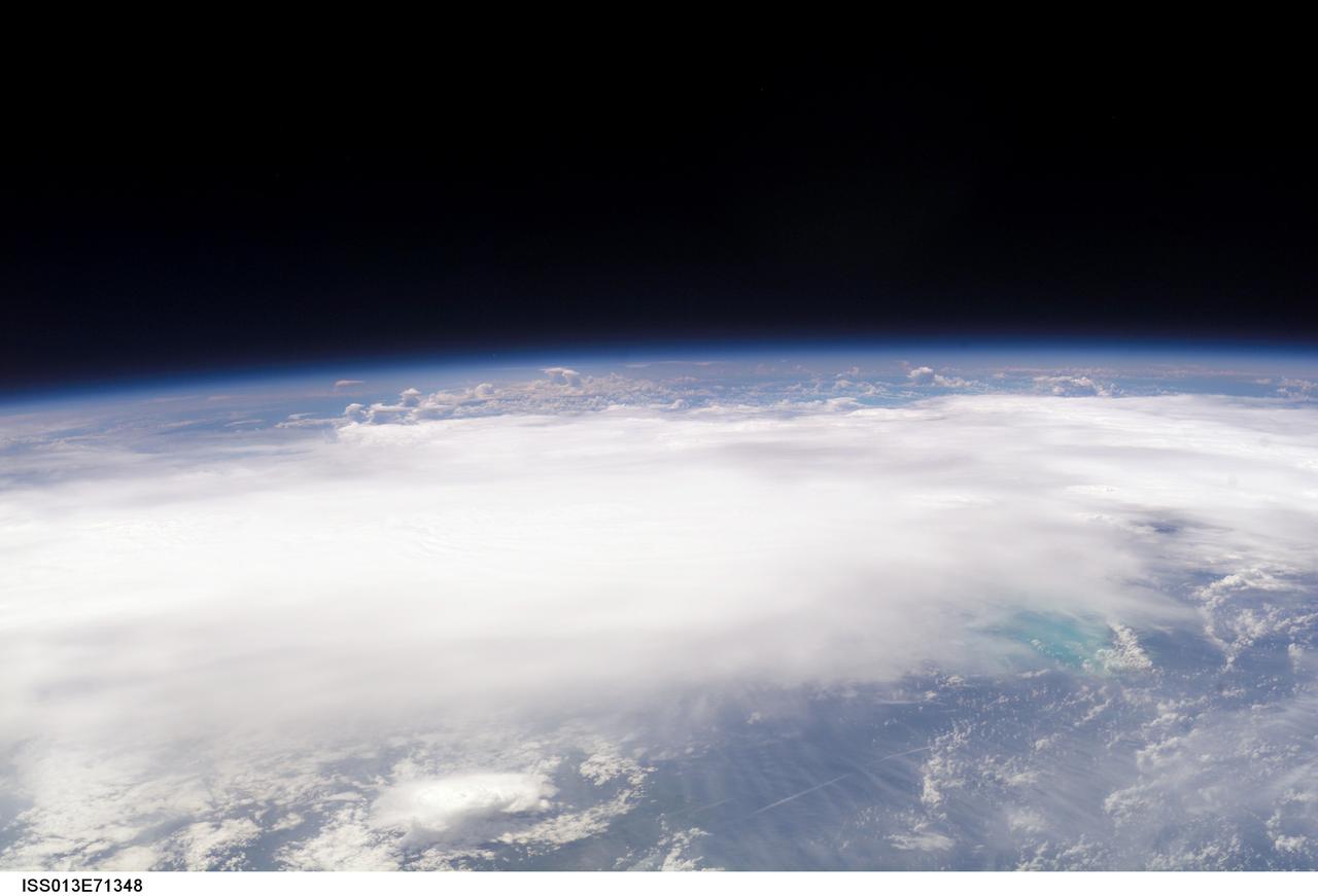 ISS013-E-71348 (28 August 2006) --- The crewmembers aboard the International Space Station took this picture of Ernesto early afternoon on August 28, 2006. The tropical storm's center was located near 20.3 degrees north latitude and 75.7 degrees west longitude when the photo was taken. Movement was toward the northwest at 9 nautical miles per hour. Maximum sustained winds were at 35 nautical miles with gusts to 45 nautical miles. Ernesto had earlier passed between the east side of the Dominican Republic and Grand Turk Island (the blue area in lower right corner).