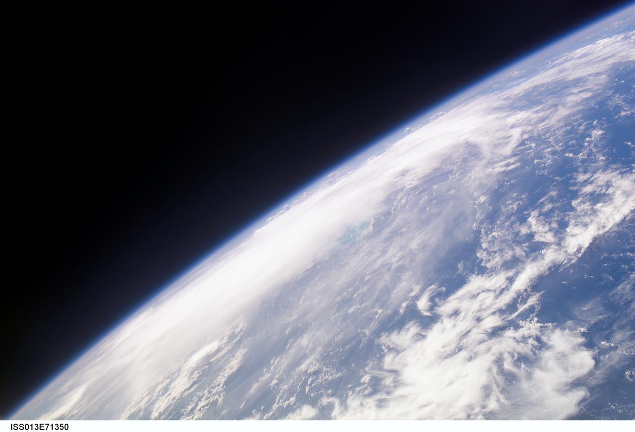 ISS013-E-71350 (28 August 2006) --- The crewmembers aboard the International Space Station took this oblique picture of Ernesto on Earth's horizon early afternoon on August 28, 2006. The tropical storm's center was located near 20.3 degrees north latitude and 75.7 degrees west longitude when the photo was taken. Movement was toward the northwest at 9 nautical miles per hour. Maximum sustained winds were at 35 nautical miles with gusts to 45 nautical miles. Ernesto had earlier passed between the east side of the Dominican Republic and Grand Turk Island (the light blue area near frame center).