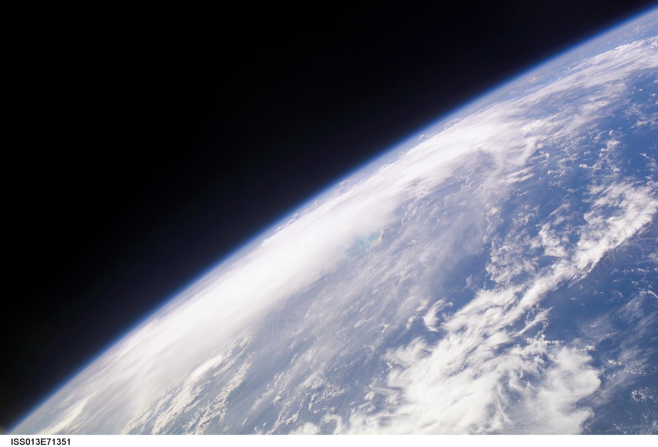 ISS013-E-71351 (28 August 2006) --- The crewmembers aboard the International Space Station took this oblique picture of Ernesto on Earth's horizon early afternoon on August 28, 2006. The tropical storm's center was located near 20.3 degrees north latitude and 75.7 degrees west longitude when the photo was taken. Movement was toward the northwest at 9 nautical miles per hour. Maximum sustained winds were at 35 nautical miles with gusts to 45 nautical miles. Ernesto had earlier passed between the east side of the Dominican Republic and Grand Turk Island (the light blue area near frame center).