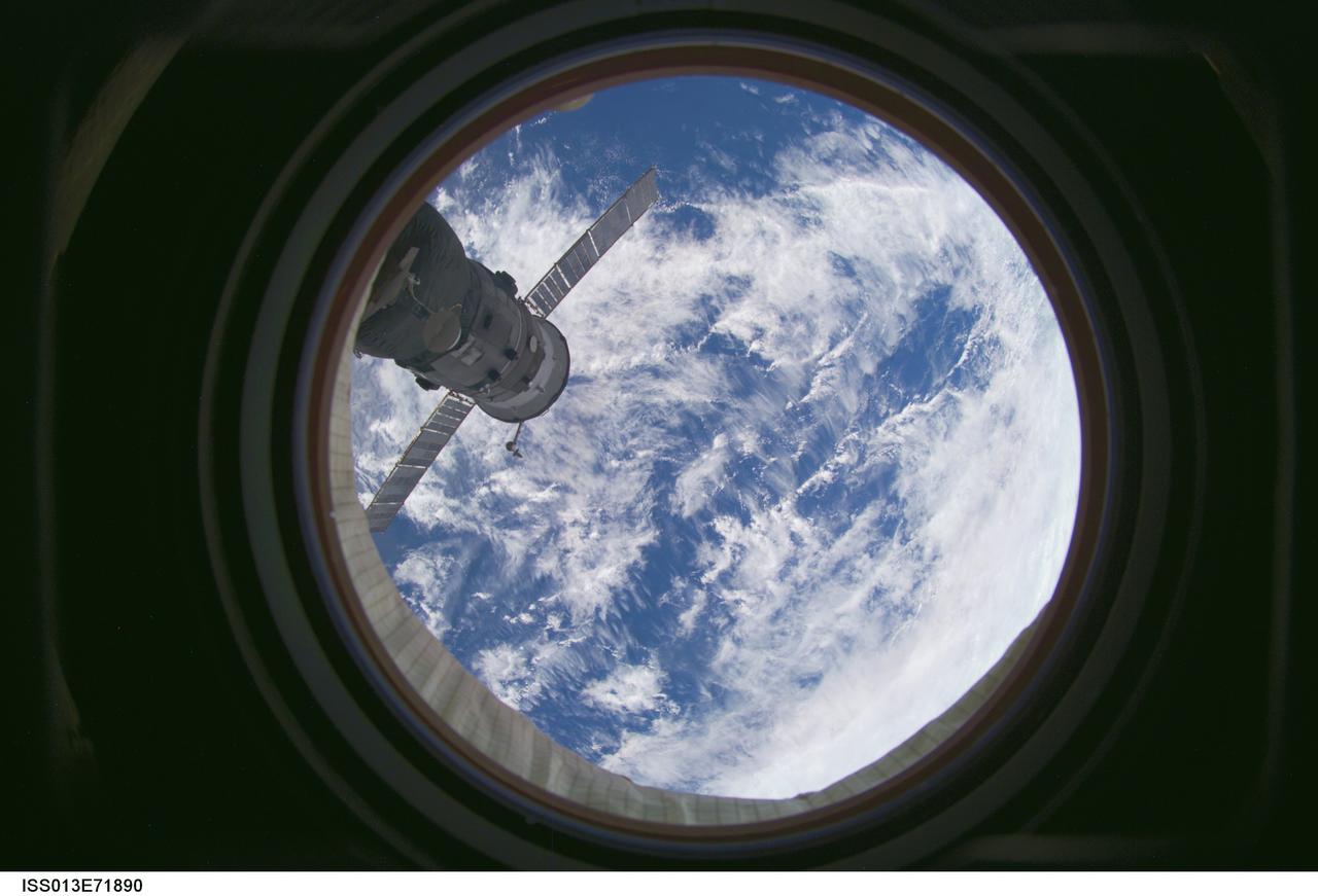 ISS013-E-71890 (28 Aug. 2006) --- A blue and white Earth and the docked Progress 22 spacecraft are featured in this image photographed by an Expedition 13 crewmember from a window on the International Space Station.