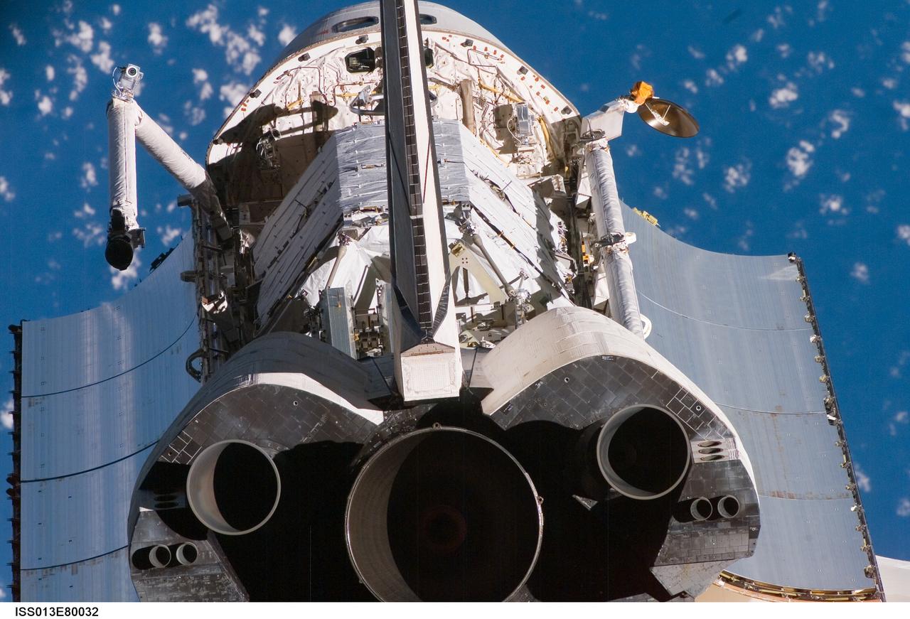 ISS013-E-80032 (11 Sept. 2006) --- A crewmember aboard the International Space Station captured this unusual angle of the Space Shuttle Atlantis with a digital still camera as the orbiter performed a backflip while it was about 600 feet from the station during its approach. The flip, done on every shuttle mission, allows a full photographic survey of the shuttle heat shield to be taken by the station crew. This image from that survey shows one of the three the main engines and extends to the shuttle's nose at the top of the frame. In between are both orbital maneuvering system (OMS) pods, part of both cargo bay doors, the aft windows of the crew cabin and part of the P3/P4 Integrated Truss Structure, the Ku-band antenna, the remote manipulator system arm and the orbiter boom sensor system (OBSS).