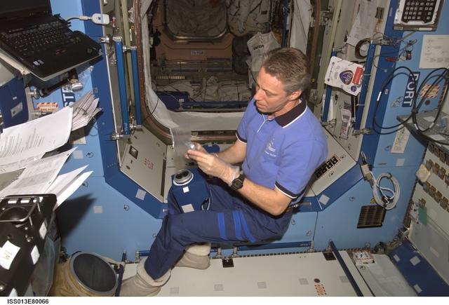 NASA image: Reiter works with SWAB ASD Filter Kit in the U.S. Laboratory during Expedition 13