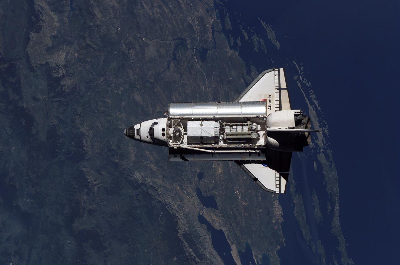 ISS013-E-80624 (11 Sept. 2006) --- This overhead image of the Space Shuttle Atlantis, recorded by an Expedition 13 crewmember onboard the International Space Station as the shuttle approached the station, gives an excellent view of the hardware stowed in the cargo bay which will later be used to resume the construction of the orbital outpost during the STS-115 mission.