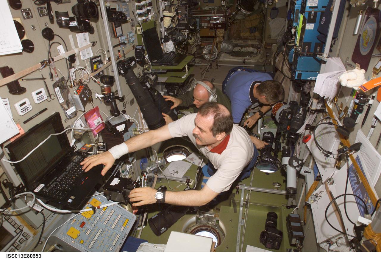 ISS013-E-80653 (11 Sept. 2006) --- The Expedition 13 crew members are pictured in the Zvezda Service Module on the International Space Station prior to welcoming the STS-115 crew. From foreground to aft are cosmonaut Pavel V. Vinogradov, commander; Jeffrey N. Williams, flight engineer and NASA station science officer; and Thomas Reiter of the the European Space Agency, flight engineer. The shuttle and space station docked this morning at 5:48 a.m. CDT to begin seven days of joint operations.