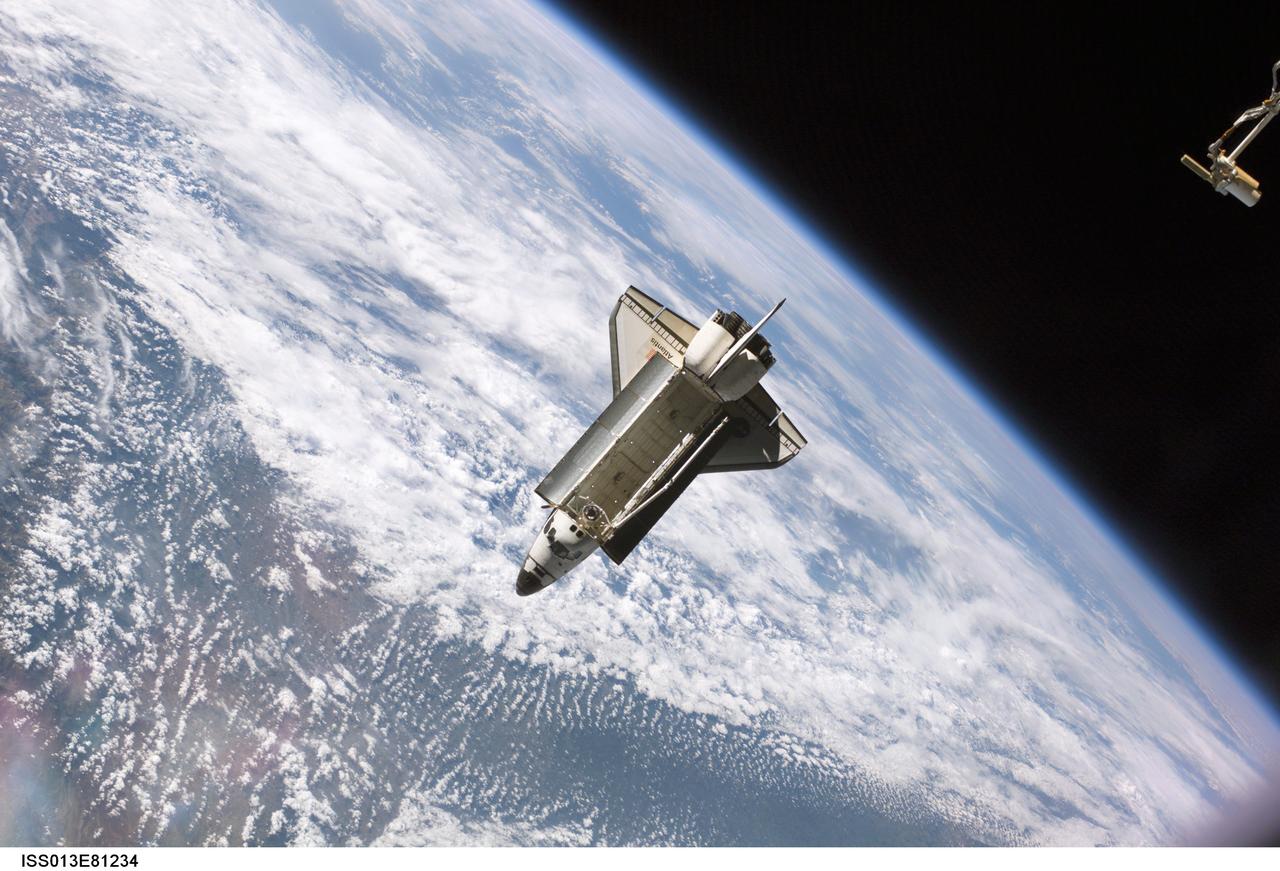 ISS013-E-81234 (17 Sept. 2006) --- The Space Shuttle Atlantis, backdropped against clouds over Earth, is pictured after it undocked from the International Space Station at 7:50 a.m. CDT, Sept. 17, 2006.  The STS-115 astronauts completed six days, two hours and two minutes of joint operations with the station crew.