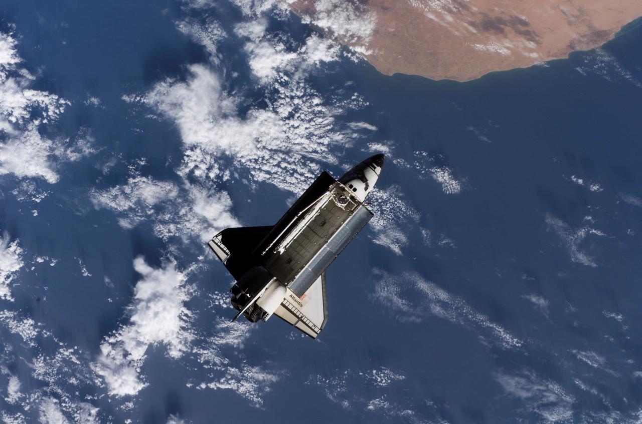 ISS013-E-81251 (17 Sept. 2006) --- The Space Shuttle Atlantis, backdropped over a colorful Earth, is pictured after it undocked from the International Space Station at 7:50 a.m. (CDT), Sept. 17, 2006. The STS-115 astronauts completed six days, two hours and two minutes of joint operations with the station crew.