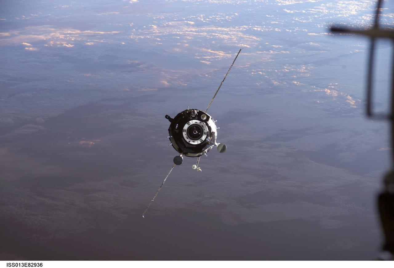 ISS013-E-82936 (20 Sept. 2006) --- Backdropped by a blue and white Earth, the Soyuz TMA-9 spacecraft approaches the International Space Station. Onboard the spacecraft are astronaut Michael E. Lopez-Alegria, Expedition 14 commander and NASA space station science officer; cosmonaut Mikhail Tyurin, Soyuz commander and flight engineer representing Russia's Federal Space Agency; and spaceflight participant Anousheh Ansari. With Tyurin at the controls, the Soyuz linked up to the Zvezda Service Module aft port at 12:21 a.m. (CDT) on Sept. 20, 2006. The docking followed Monday's launch from Baikonur Cosmodrome in Kazakhstan.