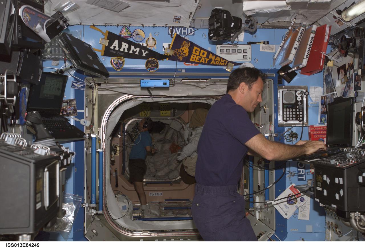 ISS013-E-84249 (23 Sept. 2006) --- Astronaut Michael E. Lopez-Alegria, Expedition 14 commander and NASA space station science officer, uses a computer in the Destiny laboratory of the International Space Station.