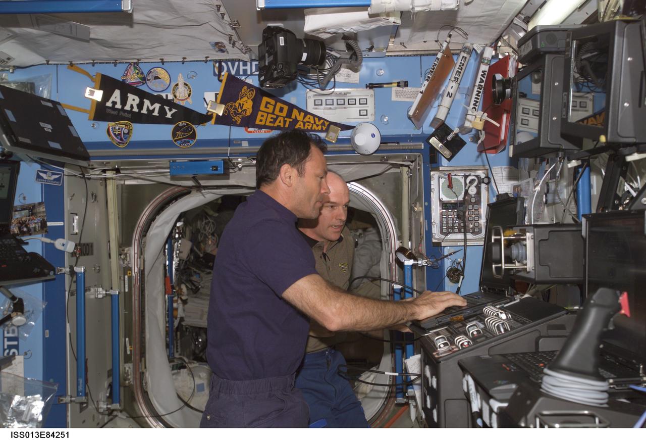 ISS013-E-84251 (23 Sept. 2006) --- Astronaut Michael E. Lopez-Alegria (foreground), Expedition 14 commander and NASA space station science officer, participates in a familiarization session with the Mobile Service System (MSS) and hands-on experience with the Canadarm2, or Space Station Remote Manipulator System (SSRMS) in the Destiny laboratory of the International Space Station. Astronaut Jeffrey N. Williams, Expedition 13 NASA space station science officer and flight engineer, assisted Lopez-Alegria.