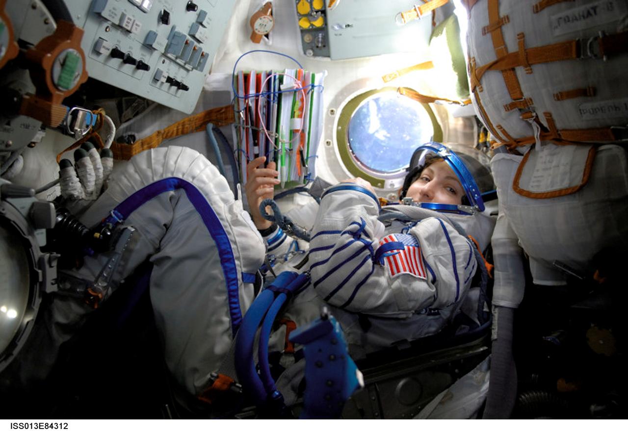 ISS013-E-84312 (18-20 Sept. 2006) --- Spaceflight participant Anousheh Ansari photographed in the Soyuz TMA-9 spacecraft in-route to the International Space Station with the Expedition 14 crewmembers. Ansari is wearing a Russian Sokol launch and entry suit.