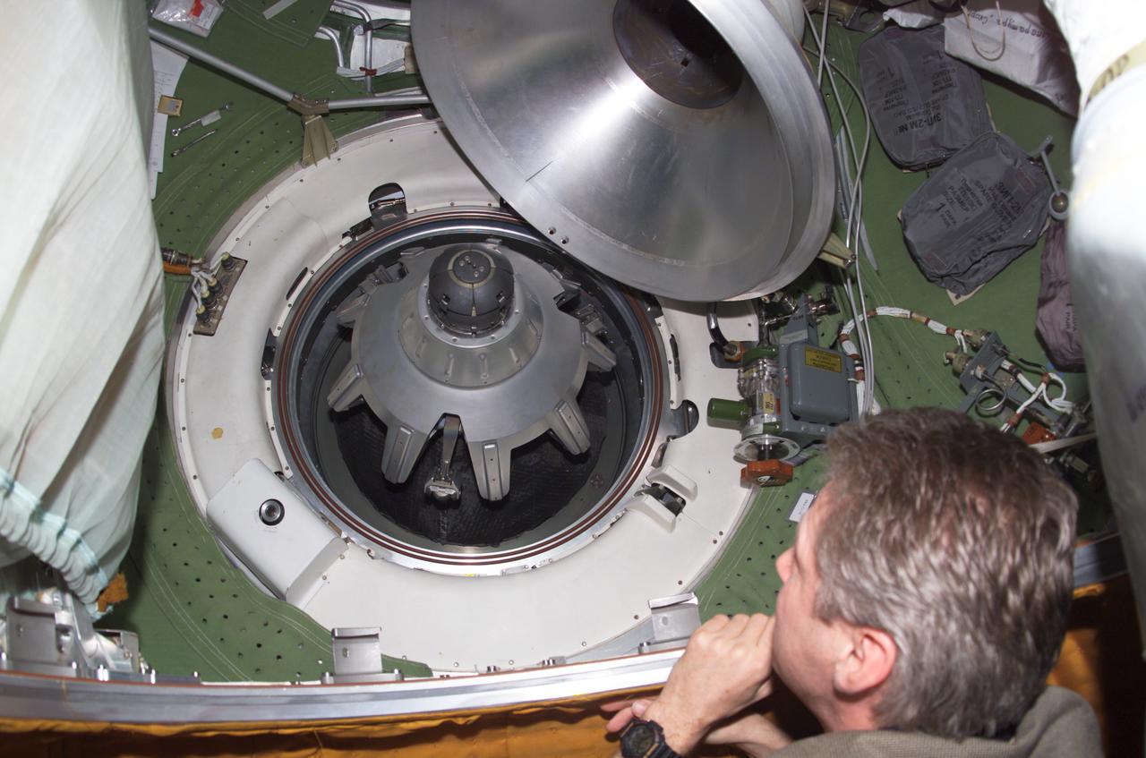 ISS014-E-05015 (28 Sept. 2006) --- European Space Agency (ESA) astronaut Thomas Reiter, Expedition 14 flight engineer, photographed near a docking port in the Pirs Docking Compartment of the International Space Station. A probe-and-cone docking mechanism is visible in the port.