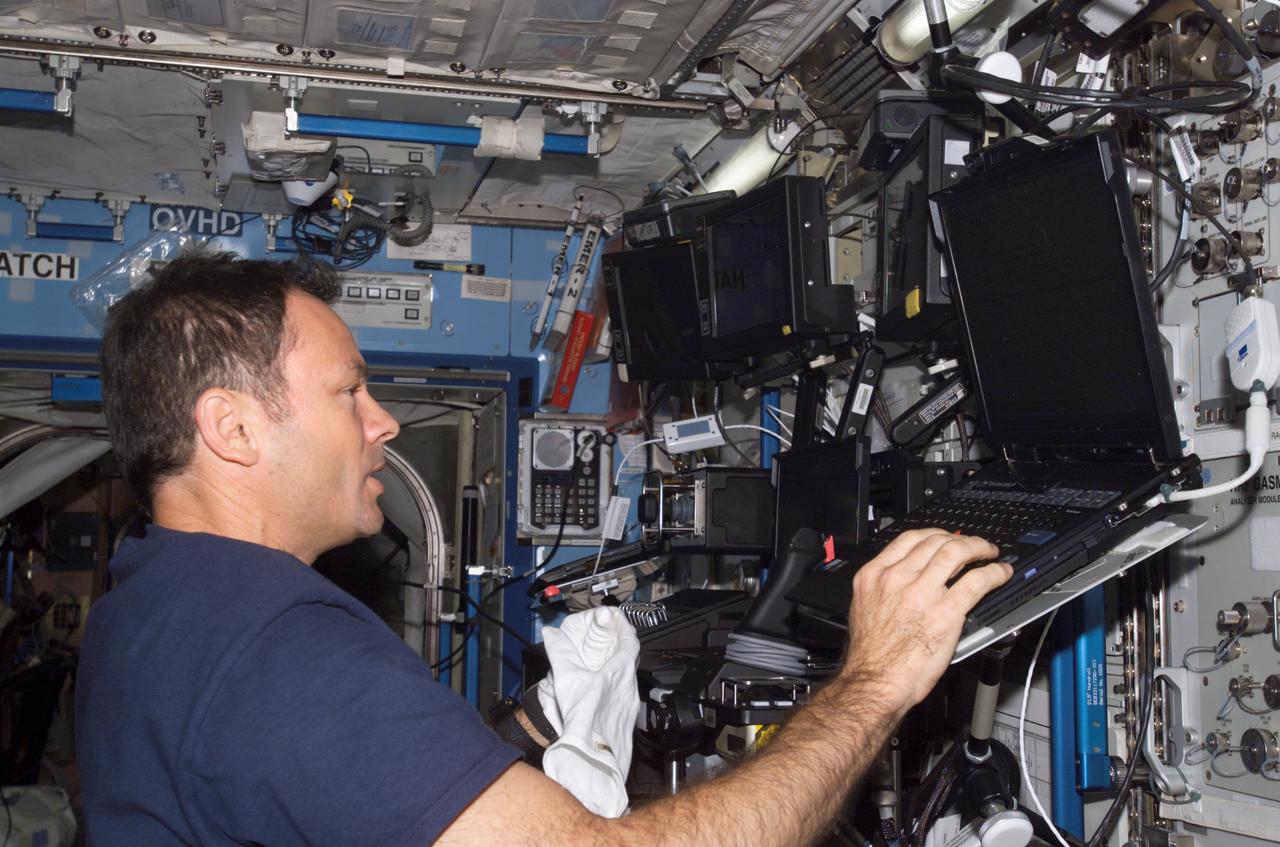 ISS014-E-05129 (3 Oct. 2006) --- Astronaut Michael E. Lopez-Alegria, Expedition 14 commander and NASA space station science officer, uses a computer in the Destiny laboratory of the International Space Station.