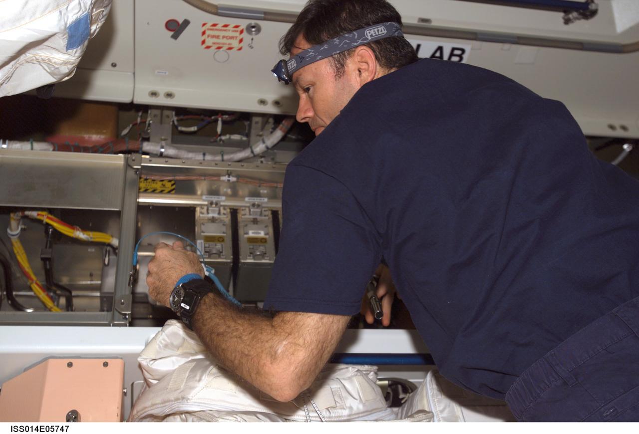 ISS014-E-05747 (16 Oct. 2006) --- Astronaut Michael E. Lopez-Alegria, Expedition 14 commander and NASA space station science officer, works with the remote power control modules (RPCM) in the Unity node of the International Space Station.