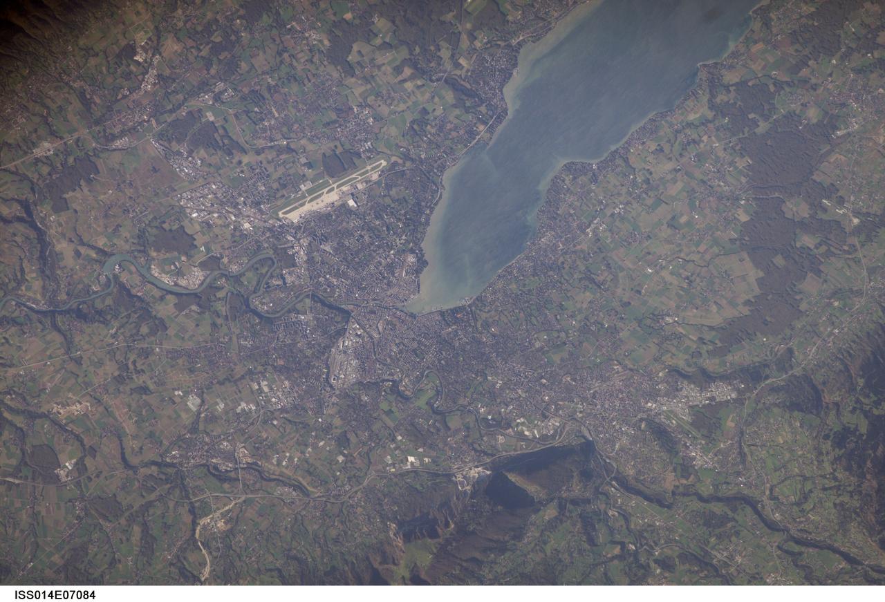 ISS014-E-07084 (2 Nov. 2006) --- Geneva, Switzerland is featured in this image photographed by an Expedition 14 crewmember on the International Space Station. The city is located at the southernmost tip of Lake Geneva (also known as Lac Leman) between two major mountain ranges, the Jura to the northwest (not shown) and the Alps to the southeast (the northern foothills of which are represented by Mount Saleve at bottom). The city's built area, roadways, and airport appear as white to grey surfaces in this view. Urbanized regions are interspersed with agricultural fields (bright green to light brown rectangular regions) and preserved forest stands (dark green) around the Lake. One of the defining moments in the city's history was the defeat of an attack by the dukedom of Savoy in 1602; the event -- known as "l'Escalade" is celebrated annually as a symbol of Geneva's independence. The city joined Switzerland as a canton (or state) in 1815. The city's recent history demonstrates its continuing importance to geopolitics. The League of Nations was headquartered here from 1919-1946, and the European headquarters of the United Nations is likewise located here. The Geneva Conventions, or "rules of war", were signed here from 1864 through 1949. The city also hosts the headquarters of numerous other international organizations and corporations - making it a "world city" of cultural, economic, and political significance.