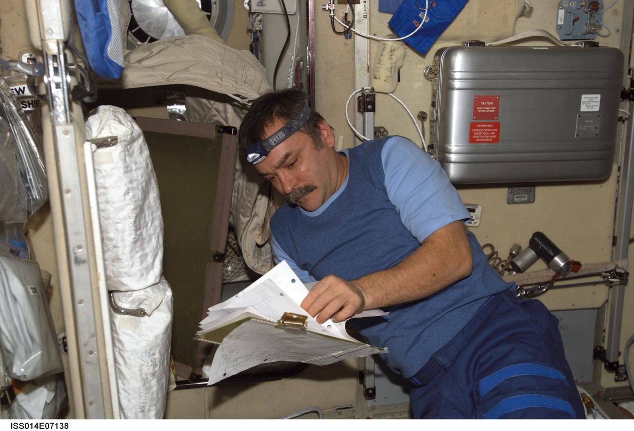 ISS014-E-07138 (3 Nov. 2006) --- Cosmonaut Mikhail Tyurin, Expedition 14 flight engineer representing Russia's Federal Space Agency, installs and connects onboard equipment control system cables in the Zvezda Service Module of the International Space Station.
