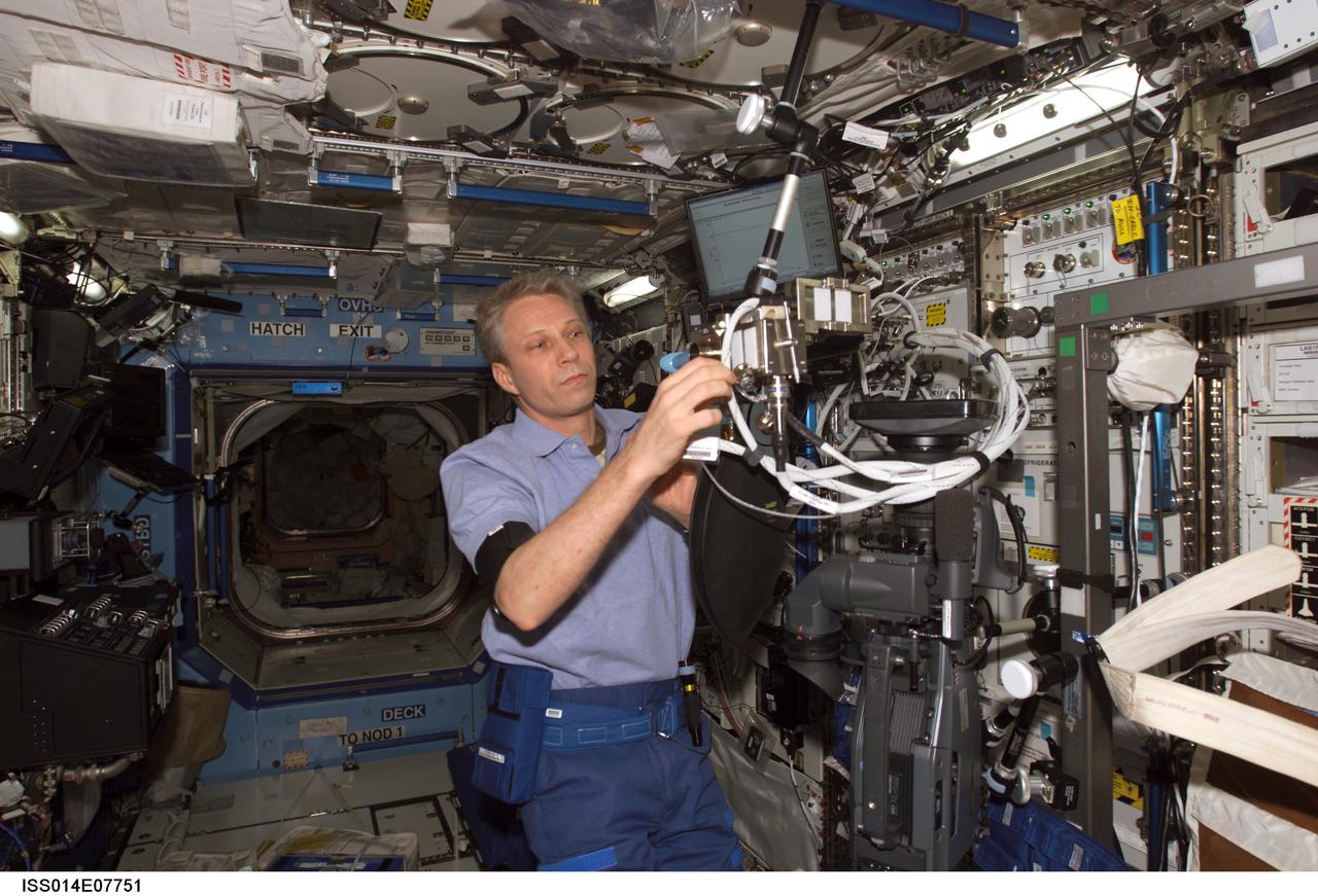 ISS014-E-07751 (10 Nov. 2006) --- European Space Agency (ESA) astronaut Thomas Reiter, Expedition 14 flight engineer, works with the Cardiac experiment--Breathing Protocol 5--in the Destiny laboratory of the International Space Station.