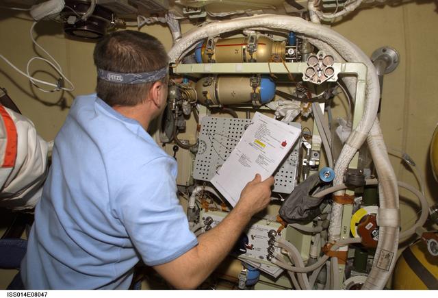 NASA image: Tyurin conducts check on Orlan interface unit in DC1