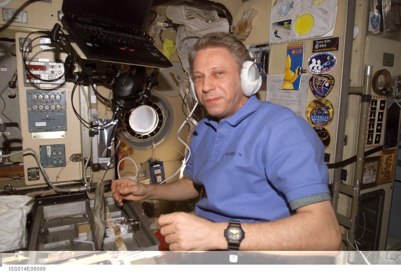 ISS014-E-08099 (22 Nov. 2006) --- European Space Agency (ESA) astronaut Thomas Reiter, Expedition 14 flight engineer, uses a communication system in the Zvezda Service Module of the International Space Station during a pre-EVA station onboard system configuration.