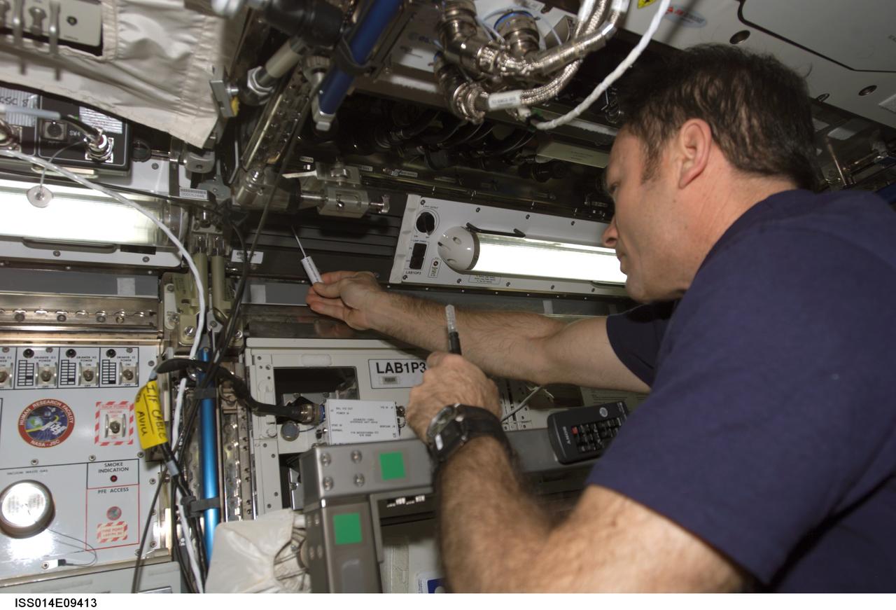 ISS014-E-09413 (8 Dec. 2006) --- Astronaut Michael E. Lopez-Alegria, Expedition 14 commander and NASA space station science officer, conducts a Surface, Water and Air Biocharacterization (SWAB) air sampling in the Destiny laboratory of the International Space Station.