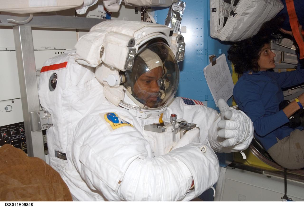 ISS014-E-09858 (14 Dec. 2006) --- Attired in his extravehicular mobility unit (EMU) spacesuit, astronaut Robert L. Curbeam, Jr., STS-116 mission specialist, prepares for the mission's second session of extravehicular activity (EVA) in the Quest Airlock of the International Space Station while Space Shuttle Discovery was docked with the station.