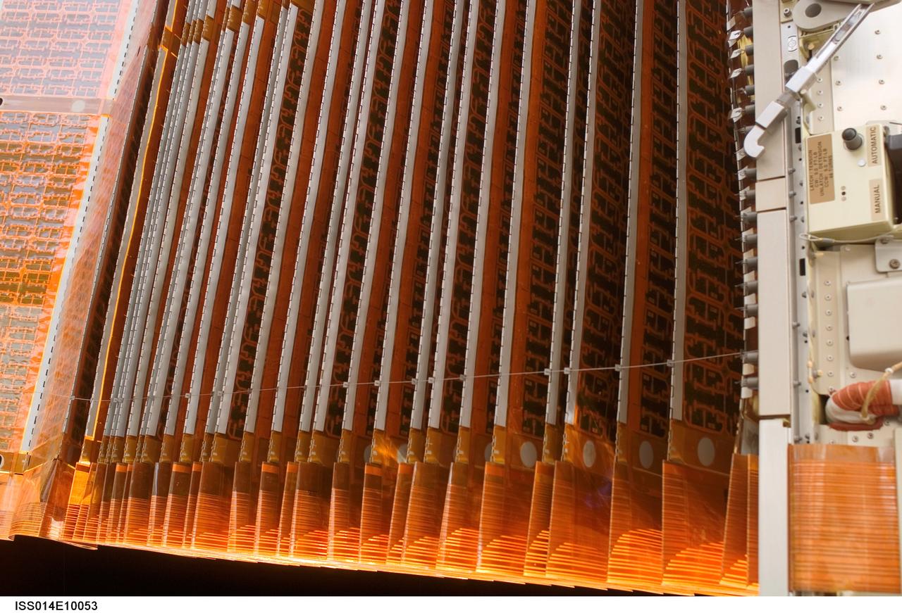 ISS014-E-10053 (18 Dec. 2006) --- A close-up view of the port overhead solar array wing on the International Space Station's P6 truss is featured in this image photographed by a STS-116 crewmember during the mission's fourth session of extravehicular activity (EVA). Astronaut Robert L. Curbeam Jr. (out of frame) and European Space Agency (ESA) astronaut Christer Fuglesang (out of frame), both mission specialists, using specially prepared, tape-insulated tools, guided the array wing neatly inside its blanket box during the 6-hour, 38-minute spacewalk.