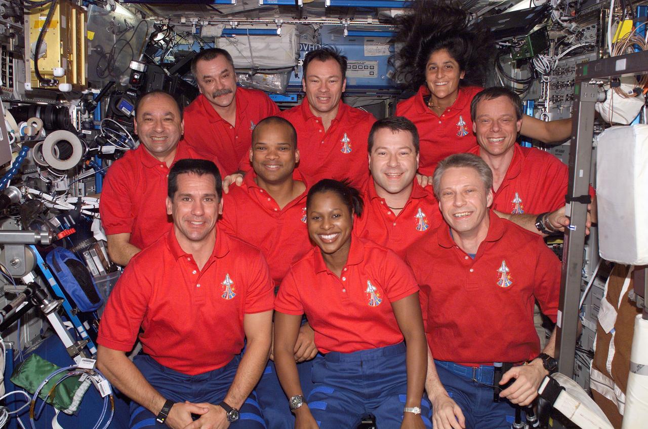 ISS014-E-10265 (19 Dec. 2006) --- The Expedition 14 and STS-116 crewmembers gather for a group portrait in the Destiny laboratory of the International Space Station while Space Shuttle Discovery was docked with the station. From the left (front row) are astronauts William A. (Bill) Oefelein, STS-116 pilot; Joan E. Higginbotham and the European Space Agency's (ESA) Thomas Reiter, both STS-116 mission specialists. From the left (center row) are astronauts Mark L. Polansky, STS-116 commander; Robert L. Curbeam Jr., Nicholas J. M. Patrick and European Space Agency's (ESA) Christer Fuglesang, all STS-116 mission specialists. From the left (back row) are cosmonaut Mikhail Tyurin, Expedition 14 flight engineer representing Russia's Federal Space Agency; astronauts Michael E. Lopez-Alegria, Expedition 14 commander and NASA space station science officer; and Sunita L. Williams, Expedition flight engineer. Shortly after the two spacecraft docked on Dec. 11, Williams became a member of the station crew. At the same time, Reiter became a Discovery crewmember for his ride home, completing about six months in space.
