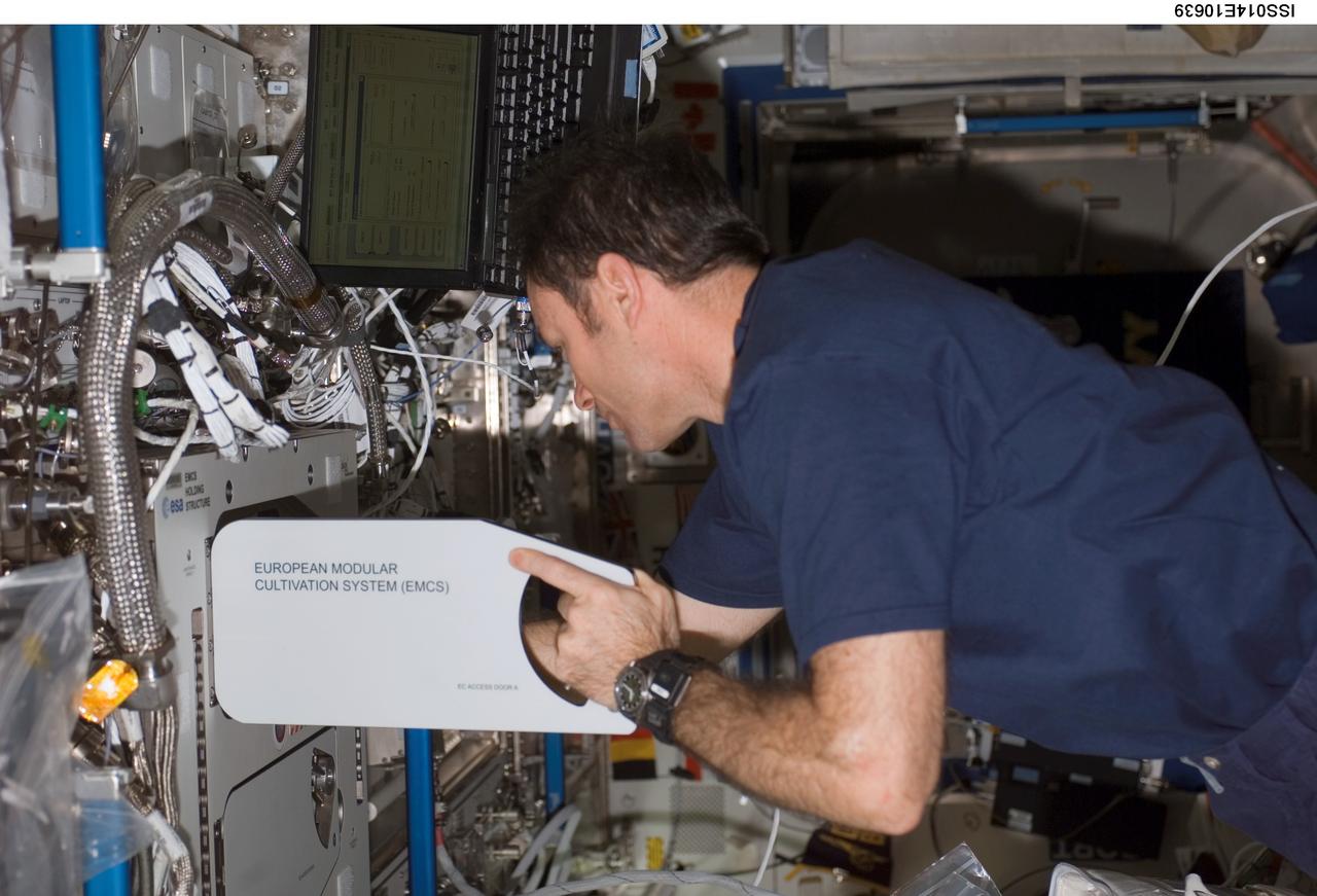 ISS014-E-10639 (29 Dec. 2006) --- Astronaut Michael E. Lopez-Alegria, Expedition 14 commander and NASA space station science officer, performs the European Modular Cultivation System (EMSC) -- Experiment Container (EC) replacement in the Destiny laboratory of the International Space Station.
