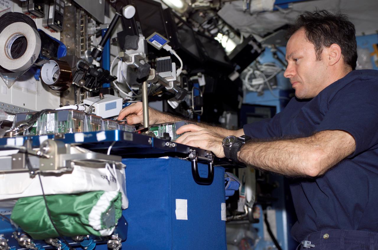 ISS014-E-10647 (29 Dec. 2006) --- Astronaut Michael E. Lopez-Alegria, Expedition 14 commander and NASA space station science officer, performs the European Modular Cultivation System (EMSC) -- Experiment Container (EC) replacement in the Destiny laboratory of the International Space Station.