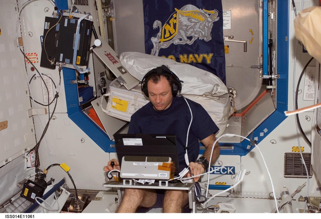 ISS014-E-11061 (2 Jan. 2007) --- Astronaut Michael E. Lopez-Alegria, Expedition 14 commander and NASA space station science officer, works with the Test of Reaction and Adaptation Capabilities (TRAC) experiment in the Destiny laboratory of the International Space Station. The TRAC investigation will test the theory of brain adaptation during space flight by testing hand-eye coordination before, during and after the space flight.