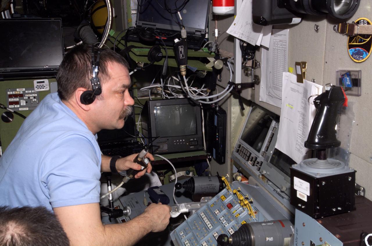 ISS014-E-12482 (19 Jan. 2007) --- Cosmonaut Mikhail Tyurin, Expedition 14 flight engineer representing Russia's Federal Space Agency, practices docking procedures with the TORU teleoperated control system in the Zvezda Service Module of the International Space Station in preparation for the docking of the Progress 24 spacecraft. Tyurin, using the Simvol-TS screen and hand controllers, could manually dock the Progress to the station in the event of a failure of the Kurs automated docking system.