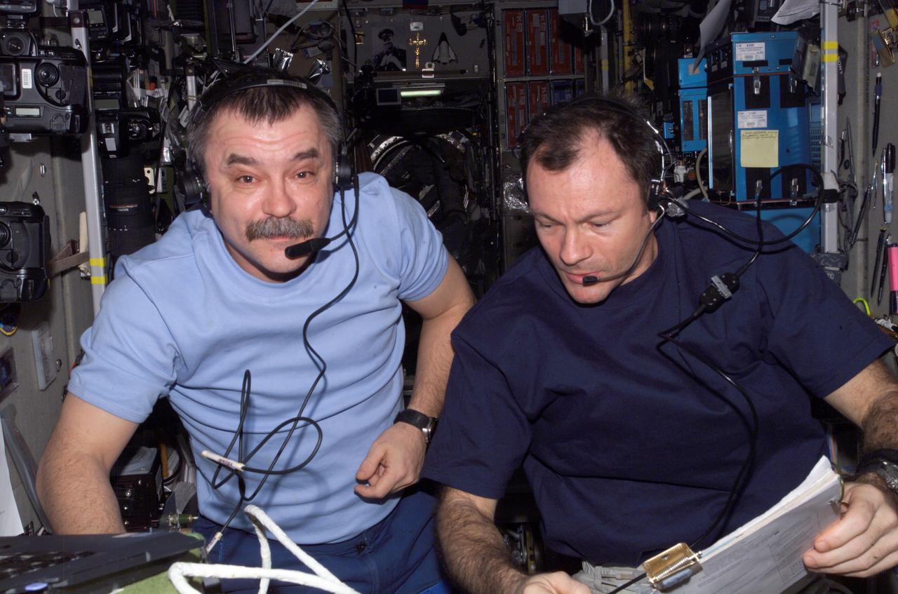 ISS014-E-12499 (19 Jan. 2007) --- Astronaut Michael Lopez-Alegria (right), Expedition 14 commander, and Russia's Federal Space Agency cosmonaut Mikhail Tyurin, flight engineer, photographed at control panels in the Zvezda Service Module of the International Space Station during the docking of Progress 24 resupply vehicle to the Pirs Docking Compartment.