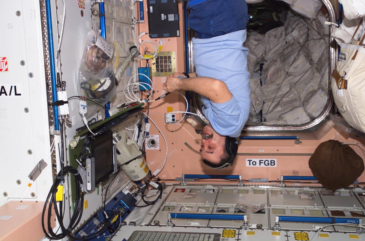 ISS014-E-12521 (21 Jan. 2007) --- Cosmonaut Mikhail Tyurin, Expedition 14 flight engineer representing Russia's Federal Space Agency, uses a communication system as he floats in the Unity node of the International Space Station.